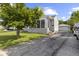 Charming home with a screened-in porch, paved driveway, and a detached garage at 633 Fletcher Ln, Beech Grove, IN 46107