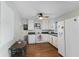 Bright kitchen with white cabinetry, appliances, and adjacent dining area at 633 Fletcher Ln, Beech Grove, IN 46107