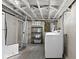 Basement laundry room with washer, dryer, and shelving at 633 Fletcher Ln, Beech Grove, IN 46107