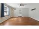 Bright living room with hardwood floors, ceiling fan, and a decorative front door at 633 Fletcher Ln, Beech Grove, IN 46107
