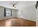 Bright living room with hardwood floors, a ceiling fan, and a decorative front door at 633 Fletcher Ln, Beech Grove, IN 46107