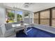 Bright sunroom with table, bench, windows, and blue carpet at 633 Fletcher Ln, Beech Grove, IN 46107