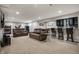 Spacious finished basement with wet bar, seating, and entertainment area at 6545 Briarwood Pl, Zionsville, IN 46077