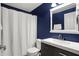 Bathroom with navy walls, white cabinets, sink, and a mirror at 6545 Briarwood Pl, Zionsville, IN 46077