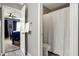 Bathroom featuring a gray wall, and a white shower curtain, with a partial view into the bedroom at 6545 Briarwood Pl, Zionsville, IN 46077