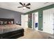 Bedroom featuring a dark wood bed frame, a ceiling fan, and doorways to the hall and bathroom at 6545 Briarwood Pl, Zionsville, IN 46077
