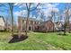 Traditional brick house with black shutters, a green lawn, mulch beds and mature trees in a suburban neighborhood at 6545 Briarwood Pl, Zionsville, IN 46077