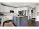 Modern kitchen with white cabinets, granite countertops, stainless steel appliances, and a gray kitchen island at 6545 Briarwood Pl, Zionsville, IN 46077