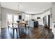 Open concept kitchen and dining area featuring an island, stainless appliances, and rustic dining table at 6545 Briarwood Pl, Zionsville, IN 46077