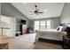 Bright main bedroom with a ceiling fan, dresser, and a large bed, great for relaxing at 6545 Briarwood Pl, Zionsville, IN 46077