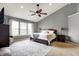 Bright main bedroom with a ceiling fan, dresser, and a large bed, great for relaxing at 6545 Briarwood Pl, Zionsville, IN 46077