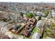 Aerial view of a neighborhood with cozy homes and tree-lined streets and a distant skyline at 741 Dequincy St, Indianapolis, IN 46201