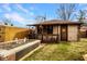 Cozy backyard with shed featuring porch, flower bed and well-maintained lawn at 741 Dequincy St, Indianapolis, IN 46201