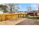 A wooden backyard deck with metal railing overlooking a fenced-in yard at 741 Dequincy St, Indianapolis, IN 46201