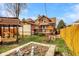 Backyard with wood fence, planting boxes and two-story home at 741 Dequincy St, Indianapolis, IN 46201