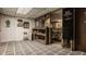Basement with tile flooring, white painted brick and finished room off to the side at 741 Dequincy St, Indianapolis, IN 46201