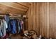 Well-organized attic closet with wood paneling and ample storage space for clothing and accessories at 741 Dequincy St, Indianapolis, IN 46201