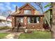 Charming brick home featuring a well-maintained lawn, decorative rock border, and inviting front entrance at 741 Dequincy St, Indianapolis, IN 46201