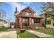 Attractive brick house with tidy lawn, steps to front door, and adjacent driveway at 741 Dequincy St, Indianapolis, IN 46201