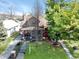 Beautifully maintained front yard with mature trees, brick walkway, and inviting entrance to this home at 741 Dequincy St, Indianapolis, IN 46201