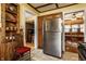 Traditional eat-in kitchen boasts stainless steel refrigerator and wood cabinets, adjoining a dining area with natural lighting at 741 Dequincy St, Indianapolis, IN 46201