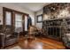 Cozy living room boasts a stone fireplace, hardwood floors, and comfortable seating at 741 Dequincy St, Indianapolis, IN 46201