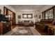 Comfortable living room with hardwood floors, area rug, and natural light from large windows at 741 Dequincy St, Indianapolis, IN 46201