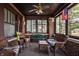 Inviting enclosed porch with wicker furniture, ceiling fan, and brick accents for relaxing outdoors at 741 Dequincy St, Indianapolis, IN 46201