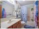 Full bathroom with a vanity and sink and tub with blue curtain at 7531 Bancaster Dr, Indianapolis, IN 46268