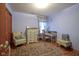 Charming bedroom features a decorative rug, a comfortable sitting area, and ample natural light at 7531 Bancaster Dr, Indianapolis, IN 46268