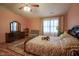 Bedroom with sloped ceilings, natural light, and wooden floors, creating a warm, inviting space at 7531 Bancaster Dr, Indianapolis, IN 46268