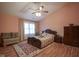 Comfortable bedroom with sloped ceiling, natural light, ceiling fan, and hardwood flooring at 7531 Bancaster Dr, Indianapolis, IN 46268