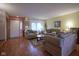 Cozy living room with wood floors, featuring comfortable seating and a view of the front door at 7531 Bancaster Dr, Indianapolis, IN 46268