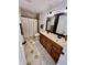 Well-appointed bathroom with double vanity, decorative mirrors, and tiled shower at 7874 E County Road 200 N, Avon, IN 46123