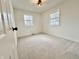 Bright bedroom featuring neutral carpet, white walls, and natural light from two windows at 7874 E County Road 200 N, Avon, IN 46123