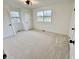 Bright bedroom with neutral carpet, white walls, and two windows at 7874 E County Road 200 N, Avon, IN 46123