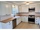Modern kitchen featuring white cabinets, stainless steel appliances, and butcher block countertops at 7874 E County Road 200 N, Avon, IN 46123