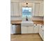 Bright kitchen featuring white cabinets, subway tile backsplash, butcher block counters and a farmhouse sink at 7874 E County Road 200 N, Avon, IN 46123