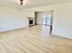 Spacious living room with neutral walls, wood-look floors, fireplace, and sliding glass doors at 7874 E County Road 200 N, Avon, IN 46123