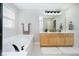 Bathroom featuring double sinks, a bathtub, and stylish black fixtures at 8253 Belcrest Ct, Indianapolis, IN 46256