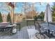 View of the cozy deck with furniture and BBQ grill looking out onto a well-maintained yard at 8253 Belcrest Ct, Indianapolis, IN 46256
