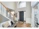 Bright foyer featuring hardwood floors, staircase, and a large window above the door at 8253 Belcrest Ct, Indianapolis, IN 46256