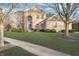 Two-story brick home with arched entryway, green lawn and mature trees at 8253 Belcrest Ct, Indianapolis, IN 46256