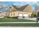 Home featuring an attached two-car garage and well-maintained lawn at 8253 Belcrest Ct, Indianapolis, IN 46256