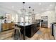 Kitchen featuring a central island with barstool seating, granite countertops and stainless steel appliances at 8253 Belcrest Ct, Indianapolis, IN 46256