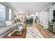 Bright, open concept living room with modern furnishings flowing into the kitchen with an island at 8253 Belcrest Ct, Indianapolis, IN 46256