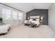 Spacious main bedroom featuring a decorative accent wall, plush bedding, and plenty of natural light at 8253 Belcrest Ct, Indianapolis, IN 46256