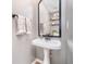 Classic powder room with a pedestal sink, black hardware, and decorative mirror at 8253 Belcrest Ct, Indianapolis, IN 46256