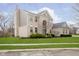 View of the rear exterior, with a brick facade, chimney and well-kept lawn at 8253 Belcrest Ct, Indianapolis, IN 46256