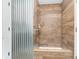 Modern walk-in shower with wood-look tile surround and a silver shower door at 8253 Belcrest Ct, Indianapolis, IN 46256